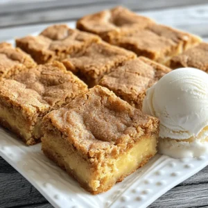 - 1 cup unsalted butter, melted - 1 ½ cups packed brown sugar - 2 large eggs - 1 teaspoon vanilla extract The main ingredients for Cinnamon Snickerdoodle Blondies create a rich and gooey base. Unsalted butter gives a creamy texture. Brown sugar makes the blondies sweet and chewy. Eggs bind the mixture, adding moisture. Vanilla extract adds a warm flavor that enhances every bite. - 2 cups all-purpose flour - 1 teaspoon baking powder - 1 teaspoon ground cinnamon - ½ teaspoon salt - ¼ teaspoon baking soda The dry ingredients are essential for structure. All-purpose flour forms the base of the blondies. Baking powder and baking soda help them rise. Ground cinnamon provides that signature snickerdoodle taste. Salt enhances the overall flavor, balancing the sweetness. - 2 tablespoons granulated sugar - 1 teaspoon ground cinnamon The topping ingredients add a sweet, spiced crunch. Granulated sugar creates a nice contrast to the soft blondies. Ground cinnamon ties in the warm, comforting flavor we love in snickerdoodles. This topping is a must for that perfect finish! - Preheat your oven to 350°F (175°C). - Get a 9x13 inch baking dish ready. You can grease it with butter or use parchment paper. This helps with easy removal after baking. - In a big bowl, whisk the melted butter and brown sugar together. Mix until it looks smooth and creamy. - Add the eggs, one at a time, whisking well after each. This helps blend everything nicely. Then, stir in the vanilla extract for extra flavor. - In a different bowl, whisk together the dry ingredients: flour, baking powder, ground cinnamon, salt, and baking soda. - Gradually add this dry mix into the wet ingredients. Stir gently until just combined. Don’t overmix it! This keeps the blondies soft and chewy. - Pour the batter into your baking dish. Spread it out evenly with a spatula or the back of a spoon. - In a small bowl, mix together the granulated sugar and ground cinnamon for the topping. Sprinkle this mixture over the batter. - Bake in the preheated oven for 20-25 minutes. Check for doneness by inserting a toothpick in the center. It should come out clean or with a few moist crumbs. This means they are ready! - Once baked, take the dish out and let the blondies cool in the pan for about 10 minutes. After that, move them to a wire rack to cool completely. This step keeps their texture just right. To make cinnamon snickerdoodle blondies, texture is key. Do not overmix your batter. Overmixing can make the blondies tough. Mix just until you see no dry flour. This keeps them soft and chewy. Pay close attention to your baking time. Bake for 20-25 minutes, but watch closely. The edges should turn golden brown. A toothpick should come out clean or with a few moist crumbs. This tells you they are done! For a great look, dust the blondies with cinnamon sugar. It adds color and a tasty touch. Serve them on a nice plate to impress your guests. Pair these blondies with a scoop of vanilla ice cream. The cold creaminess matches well with the warm, sweet blondies. You can also enjoy them with a cup of coffee. The flavors blend beautifully together. Use high-quality vanilla extract to boost flavor. It makes a big difference! You can also try different types of sugar in your recipe. Brown sugar adds depth, while granulated sugar gives sweetness. Mixing them can create a unique taste. Don't be afraid to experiment! These small changes can lead to delicious surprises. {{image_4}} You can make these blondies even more fun with add-ins. Here are some tasty ideas: - Nuts: Chopped walnuts or pecans add a nice crunch and flavor. - Chocolate Chips: Mix in semi-sweet chocolate chips or white chocolate for extra sweetness. Adding these ingredients can create a new twist on the classic blondie. You can mix and match based on what you like best! You can also change up the flavor of your blondies. Here are two ideas: - Pumpkin Spice Variation: Add pumpkin spice for a fall treat. Just swap some of the cinnamon for pumpkin spice. - Almond Extract: Add a splash of almond extract for a nutty flavor that goes well with cinnamon. These twists can make your blondies unique, perfect for any occasion. If you have dietary needs, there are easy swaps you can make: - Gluten-Free Flour: Use gluten-free flour instead of all-purpose flour. This way, everyone can enjoy them. - Vegan Options: For a vegan version, use flax eggs instead of regular eggs and coconut oil instead of butter. These adjustments can help everyone enjoy your cinnamon snickerdoodle blondies! To keep your cinnamon snickerdoodle blondies fresh, use an airtight container. This prevents them from drying out. Glass or plastic containers work well. Store them at room temperature for best taste. Cinnamon snickerdoodle blondies last about 3 to 5 days at room temperature. If you want to keep them longer, freeze them. Wrap each blondie in plastic wrap, then place them in a freezer bag. They will stay good for up to three months in the freezer. Reheat your blondies in the oven for the best results. Set the oven to 350°F (175°C) and warm them for about 10 minutes. If you use a microwave, warm them in short bursts of 10-15 seconds. This helps avoid texture changes. Enjoy them warm for a delicious treat! Yes, you can use salted butter if you don't have unsalted. It will add a bit of saltiness to the blondies. This change can enhance the flavor but may make your blondies taste different. If you choose salted butter, reduce the added salt in the recipe. This way, you keep a good balance of flavors in your sweet treat. To check for doneness, use a toothpick. Insert it into the center of the blondies. If it comes out clean or with a few moist crumbs, they are done. If the toothpick has wet batter, bake for a few more minutes. Remember, blondies can be a bit gooey, so don't worry if they are not completely dry inside. The edges should look golden brown when they are ready. Leftover blondies can be used in many fun ways. You can crumble them over ice cream for a tasty sundae. You can also make a trifle by layering them with whipped cream and fruit. Another idea is to turn them into blondie bites by cutting them into smaller squares and serving them at parties. They can also be stored in an airtight container for up to a week. In this post, we covered how to make delicious blondies. We discussed key ingredients like butter, sugars, and eggs. I provided step-by-step instructions for mixing and baking. Tips for texture and serving were shared, along with fun variations and storage advice. Now, you can make the best blondies for any occasion. Enjoy experimenting with flavors and sharing your treats! Happy baking!