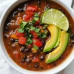 To make a delicious spicy black bean soup, gather these key ingredients: - 1 tablespoon extra virgin olive oil - 1 medium onion, finely diced - 3 cloves garlic, minced - 1 bell pepper, diced - 1 large carrot, diced - 2 celery stalks, diced - 2 cups vegetable broth (low-sodium preferred) - 1 (15 oz) can black beans, thoroughly drained and rinsed - 1 (14 oz) can diced tomatoes with green chilies - 1 teaspoon ground cumin - 1 teaspoon smoked paprika - 1 teaspoon chili powder - 1/2 teaspoon cayenne pepper - Sea salt to taste - Freshly cracked black pepper to taste - Juice of 1 fresh lime - Fresh cilantro, coarsely chopped, for garnish - Creamy avocado slices (optional) Each ingredient plays a role in building the soup's flavor. The olive oil starts the sauté, giving a rich base. The onion and garlic add sweetness and depth. Fresh vegetables like bell pepper, carrot, and celery provide crunch and color. Black beans add protein and creaminess, while diced tomatoes with green chilies bring a kick. Spices like cumin, paprika, and chili powder form the heart of the soup’s flavor. Adjust the cayenne pepper to suit your taste. Finally, lime juice brightens the soup, while cilantro and avocado make perfect garnishes. They add freshness and a creamy texture, enhancing your dish. {{ingredient_image_2}} 1. Sautéing vegetables Heat 1 tablespoon of extra virgin olive oil in a large pot over medium heat. Once the oil shimmers, add 1 medium onion, finely diced. Sauté the onion for about 5 minutes until it becomes soft and translucent. This step builds a nice base for the soup. Then, add 3 cloves of minced garlic, 1 diced bell pepper, 1 large diced carrot, and 2 diced celery stalks. Sauté these veggies for another 5 to 7 minutes until they soften and mix well. 2. Adding broth and spices Now it’s time to add flavor! Pour in 2 cups of low-sodium vegetable broth. Next, add 1 can (15 oz) of thoroughly drained and rinsed black beans and 1 can (14 oz) of diced tomatoes with green chilies. Sprinkle in 1 teaspoon of ground cumin, 1 teaspoon of smoked paprika, 1 teaspoon of chili powder, and 1/2 teaspoon of cayenne pepper. Stir everything together to combine the ingredients well. 3. Simmering the soup Raise the heat to bring the soup to a gentle simmer. Once it simmers, lower the heat, cover the pot slightly, and let it cook uncovered for 20 to 25 minutes. This allows the flavors to meld beautifully. 4. Pureeing to desired texture After simmering, you can choose how creamy you want your soup. Use an immersion blender to carefully puree a portion of the soup. If you want it smoother, pour a couple of cups into a blender, blend until smooth, and then return it to the pot. 5. Seasoning and garnishing Finally, taste your soup! Adjust the seasoning with sea salt, freshly cracked black pepper, and the juice of 1 fresh lime for that bright flavor. Serve hot, garnished with coarsely chopped fresh cilantro and creamy avocado slices, if you like. This step-by-step guide will help you create a flavorful and nutritious spicy black bean soup that warms the heart and delights the taste buds. Enjoy your cooking! - Adjusting spice levels: Start with one teaspoon of chili powder. Taste the soup and add more if you want it spicier. You can also use cayenne pepper for extra heat. - Using fresh versus canned ingredients: Fresh veggies bring great flavor! However, canned beans save time. Use low-sodium options for a healthier soup. - Best practices for sautéing: Sauté onion until soft, about five minutes. This step adds sweetness. Add garlic later to avoid burning. Cook veggies until they soften. - Using an immersion blender: This tool is great for pureeing the soup. It’s easy to use and saves time. Just blend a portion until creamy right in the pot. - Suggested pot types for cooking: A large, heavy-bottomed pot works best. It helps with even cooking and prevents burning. Look for one with a lid to cover when simmering. Pro Tips Fresh Ingredients Matter: Using fresh vegetables and herbs will enhance the flavor profile of your soup significantly. Opt for organic produce when possible for the best taste. Customize the Heat: Adjust the chili powder and cayenne pepper according to your heat preference. Start with less and add more as needed to avoid overpowering the dish. Perfectly Creamy Texture: For a smoother soup, blend a portion of the soup or all of it, depending on your texture preference. This will add a rich creaminess without using dairy. Garnish for Flavor: Don’t skip the garnishes! Fresh cilantro and avocado add not only a visual appeal but also a delightful flavor contrast that elevates the soup. {{image_4}} You can change the beans in this soup. Try pinto beans or kidney beans for a new taste. Each type brings its own flavor and texture. You can also swap out some vegetables. Zucchini, corn, or even sweet potatoes work great. Each adds a unique twist to the soup. Want to add some protein? You can mix in cooked chicken or tofu. This makes the soup more filling and hearty. This soup can easily fit into a vegan diet. Just ensure the vegetable broth is vegan. It’s naturally gluten-free since it has no wheat or gluten products. You can create low-sodium options too. Use low-sodium broth and limit added salt. This makes the soup healthier while keeping it tasty. To store leftovers, let the soup cool first. Then, pour it into an airtight container. This helps keep it fresh. I recommend glass or BPA-free plastic containers. They seal well and do not absorb odors. For freezing, wait until the soup cools completely. Pour it into freezer-safe containers. Leave some space at the top, as the soup will expand. This helps to prevent spills. To thaw, place the container in the fridge overnight. You can also use the microwave for quick thawing. When ready to eat, reheat on the stove. Stir often until it’s hot. If needed, add a splash of broth or water to loosen it up. Enjoy your soup anytime! Spicy black bean soup is a hearty dish made with black beans, veggies, and spices. It has a rich flavor with a nice kick. The key ingredients include black beans, diced tomatoes, and spices like cumin and chili powder. This soup is filling and packed with nutrients. Yes, you can make spicy black bean soup in a slow cooker! Just follow these steps: - Sauté onions and garlic in a pan. - Add all ingredients to the slow cooker. - Cook on low for 6-8 hours or high for 3-4 hours. This method allows flavors to deepen and meld beautifully. To adjust the spice level, add more chili powder or cayenne for heat. For a milder flavor, reduce these spices or omit cayenne. You can also add a dollop of sour cream or yogurt for creaminess. This helps balance the heat if needed. Black bean soup is very nutritious. Here are some benefits: - High in fiber, promoting good digestion. - A great source of plant-based protein. - Packed with vitamins and minerals, like iron and folate. - Low in fat, making it a heart-healthy choice. This soup supports a balanced diet and keeps you full. Spicy black bean soup lasts about 3-5 days in the fridge. To store, let the soup cool first. Then, place it in an airtight container. Make sure to reheat it thoroughly before serving. If you want to keep it longer, consider freezing the soup. This blog post covered how to make spicy black bean soup from scratch. I shared required ingredients, step-by-step instructions, and tips to enhance flavor. You learned about variations, storage tips, and answered common questions. In conclusion, this soup is tasty and easy to adjust. You can make it your own with different veggies or spice levels. Enjoy making and sharing this delicious meal!